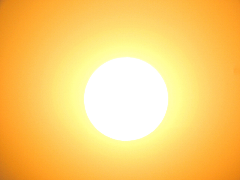 Sun beams down in an orange sky