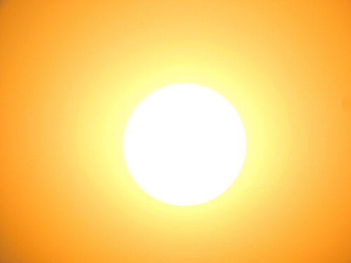 Sun beams down in an orange sky
