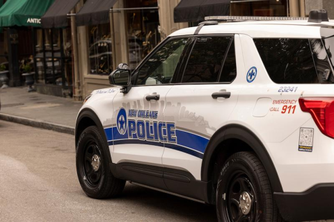NOPD car parked next ot a sidewalk