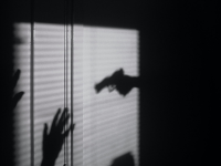 Shadow of gun and hands up