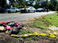 Crimes scene tape and abandoned shoes discarded on street