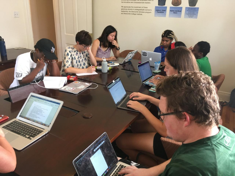 students around table on laptop