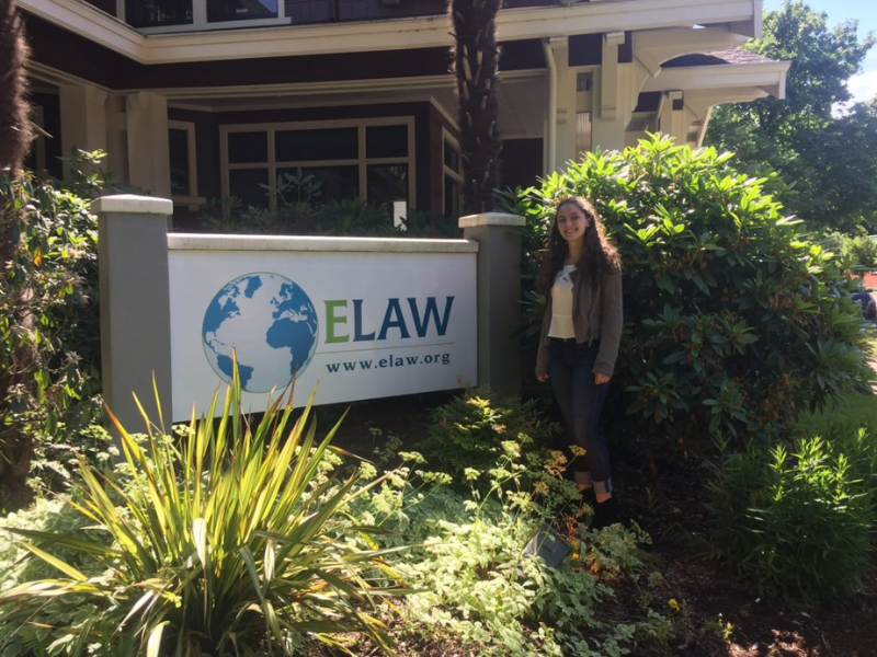 Environmental Law Alliance Worldwide (ELAW) sign outside and student