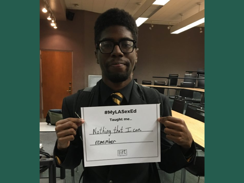 student holding up sign