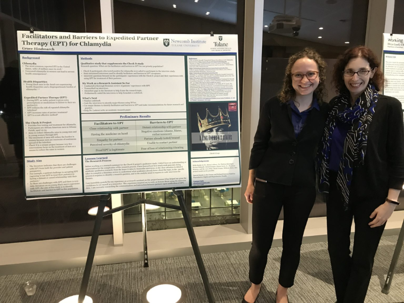 student in front of scientific poster