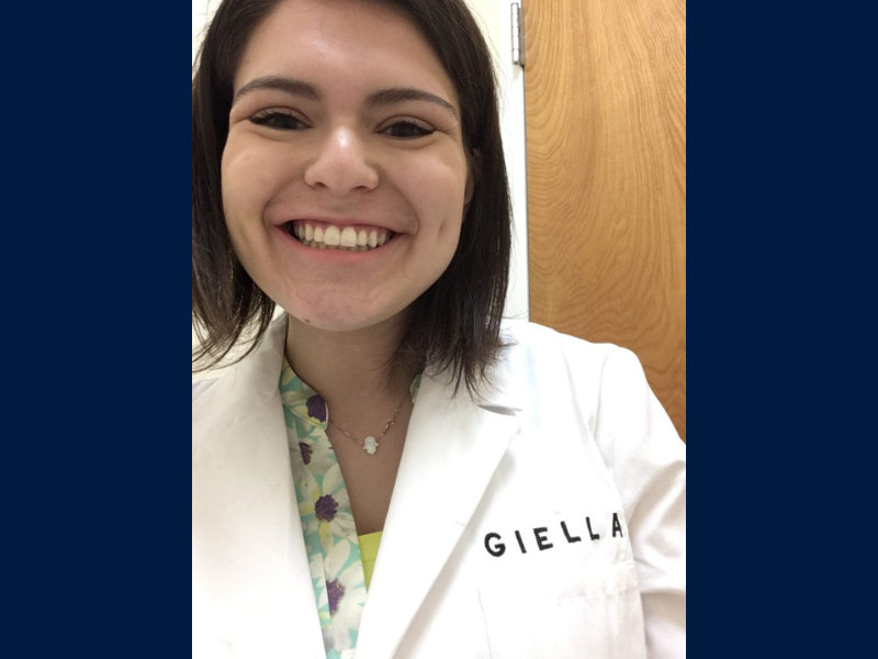 student looking very excited about wearing a GIELLA lab coat in the warehouse